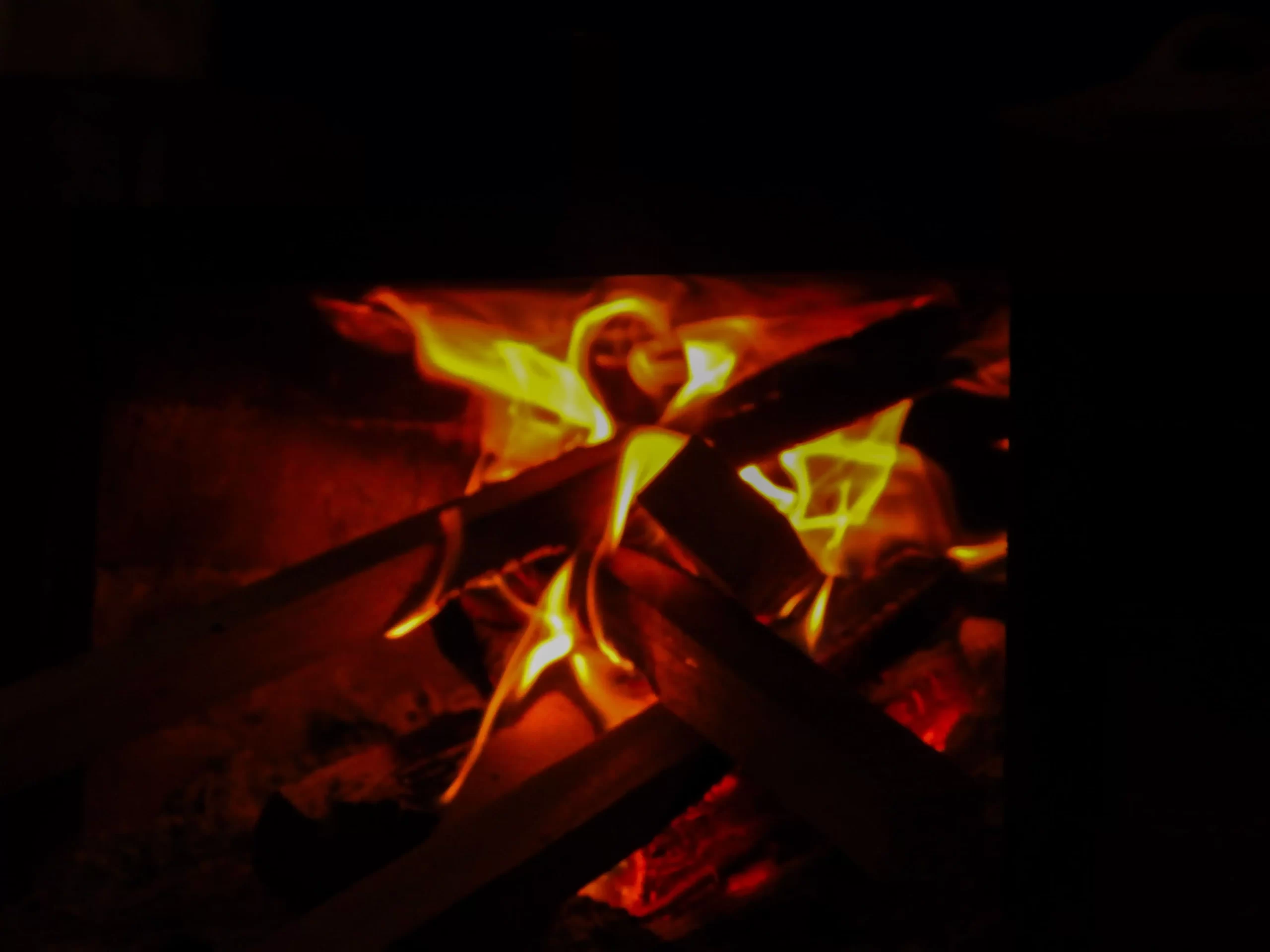 Close-up of a traditional wood fire burning brightly inside a rustic stove in La Fortuna Costa Rica.